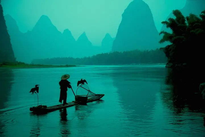Chinese cormorant fisherman on the Li River in the morning