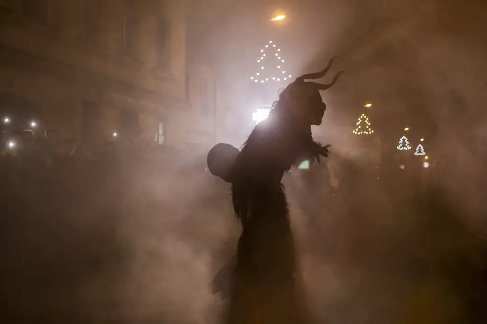 KAPLICE, CZECH REPUBLIC - DECEMBER 12: A participant dressed as the Krampus creature walks the streets during Krampus gathering on December 12, 2015 in Kaplice, Czech Republic. Krampus, also called Tuifl or Perchten, is a demon-like creature represented by a fearsome, hand-carved wooden mask with animal horns, a suit made from sheep or goat skin and large cow bells attached to the waist that the wearer rings by running or shaking his hips up and down. Krampus has been a part of Central European, alpine folklore going back at least a millennium, and since the 17th-century Krampus traditionally accompanies St. Nicholas and angels on the evening of December 5 to visit households to reward children that have been good while reprimanding those who have not. However, in the last few decades the western Austrian region of Tyrol in particular has seen the founding of numerous village Krampus associations with up to 100 members each and who parade without St. Nicholas at Krampus events throughout November and early December. In the last few years, Czech towns, placed on the border with Austria, invite Austrian Krampus groups into towns for parades as a new tradition during Advent.Ê (Photo by Matej Divizna/Getty Images)