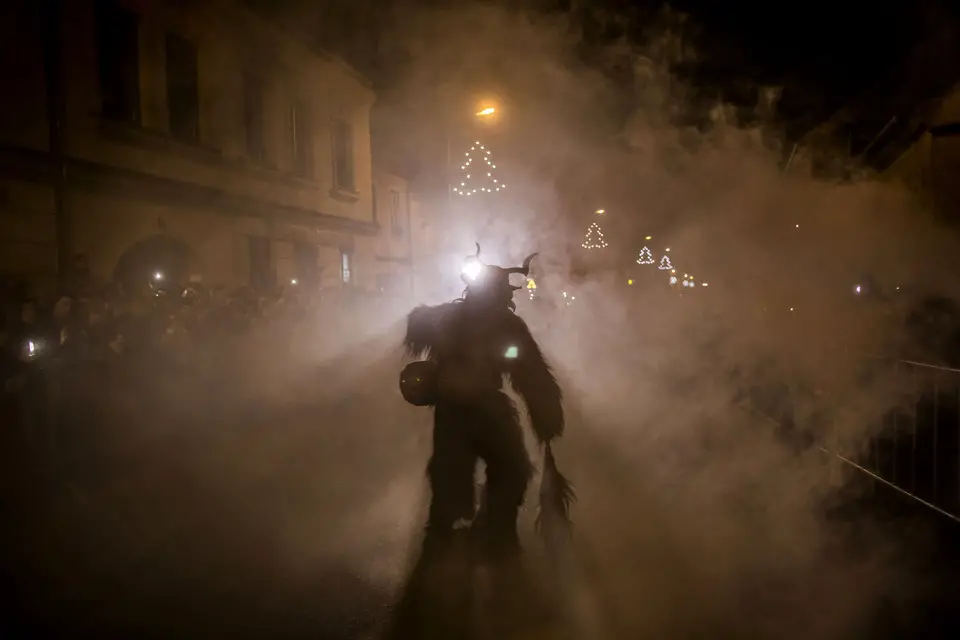 KAPLICE, CZECH REPUBLIC - DECEMBER 12: A participant dressed as the Krampus creature walks the streets during Krampus gathering on December 12, 2015 in Kaplice, Czech Republic. Krampus, also called Tuifl or Perchten, is a demon-like creature represented by a fearsome, hand-carved wooden mask with animal horns, a suit made from sheep or goat skin and large cow bells attached to the waist that the wearer rings by running or shaking his hips up and down. Krampus has been a part of Central European, alpine folklore going back at least a millennium, and since the 17th-century Krampus traditionally accompanies St. Nicholas and angels on the evening of December 5 to visit households to reward children that have been good while reprimanding those who have not. However, in the last few decades the western Austrian region of Tyrol in particular has seen the founding of numerous village Krampus associations with up to 100 members each and who parade without St. Nicholas at Krampus events throughout November and early December. In the last few years, Czech towns, placed on the border with Austria, invite Austrian Krampus groups into towns for parades as a new tradition during Advent.Ê (Photo by Matej Divizna/Getty Images)